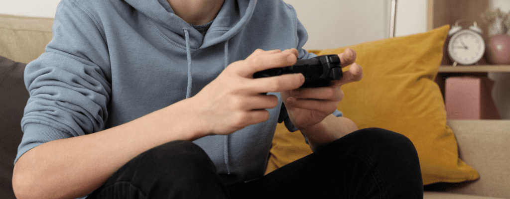 teen holding video game controller